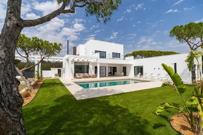 a white house with a swimming pool and a yard at ALBA SEA VILLA in Chiclana de la Frontera