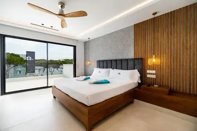 a bedroom with a large bed and a large window at ALBA SEA VILLA in Chiclana de la Frontera