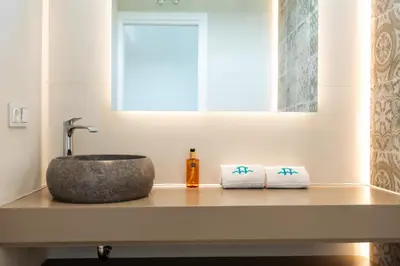 a bathroom with a sink and two towels on a counter at ALBA SEA VILLA in Chiclana de la Frontera