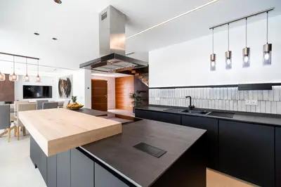 a kitchen with black cabinets and a wooden counter top at ALBA SEA VILLA in Chiclana de la Frontera