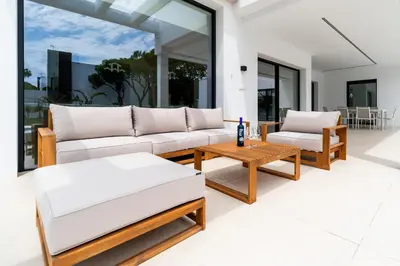 a living room with white furniture and large windows at ALBA SEA VILLA in Chiclana de la Frontera