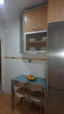a kitchen with a table and a stainless steel refrigerator at Piso en San Fernando (Cádiz) in San Fernando