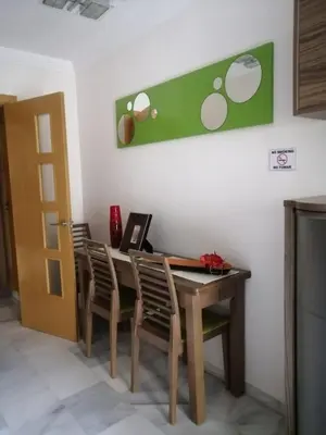a dining room with a wooden table and chairs at Piso en San Fernando (Cádiz) in San Fernando