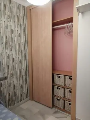 a walk in closet with a door and baskets at Piso en San Fernando (Cádiz) in San Fernando