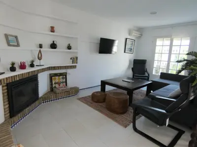 a living room with a couch and a fireplace at Quinta La Solana in Chiclana de la Frontera