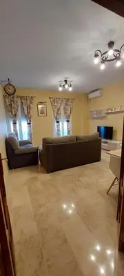 a living room with two couches and a tv at El piso de Manuel in Sanlúcar de Barrameda