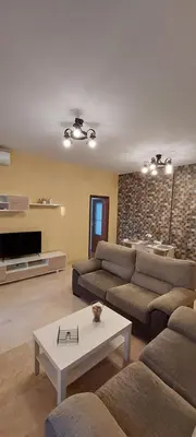 a living room with a couch and a table at El piso de Manuel in Sanlúcar de Barrameda