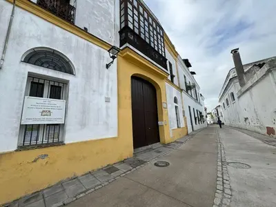 a yellow and white building on the side of a street at El piso de Manuel in Sanlúcar de Barrameda