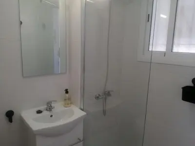 a white bathroom with a shower and a sink at 3 bedroom Apartment in San Fernando in San Fernando