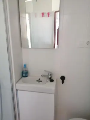a white bathroom with a sink and a mirror at 3 bedroom Apartment in San Fernando in San Fernando