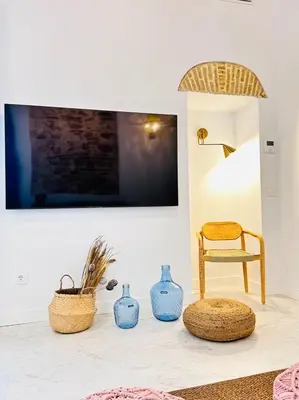 a living room with blue vases and a chair at inncadiz Casa Los Balbos in Cádiz