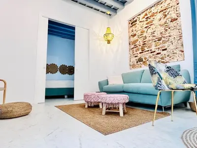 a living room with a blue couch and a table at inncadiz Casa Los Balbos in Cádiz