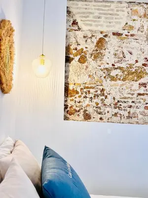 a living room with a couch and a painting on the wall at inncadiz Casa Los Balbos in Cádiz