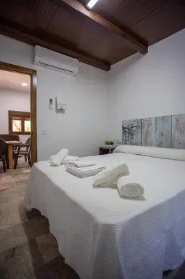 a white bed with white towels on top of it at Casa Caramelo in Medina Sidonia