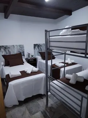 a room with two bunk beds and a ladder at Casa Caramelo in Medina Sidonia