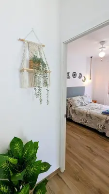 a room with a bedroom with a bed and a mirror at Conil fuente del gallo in Conil de la Frontera