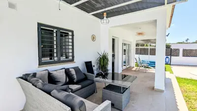a living room with a couch and a table at Conil fuente del gallo in Conil de la Frontera