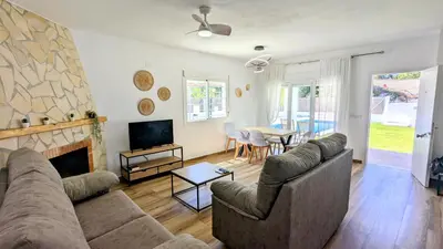 a living room with a couch and a fireplace at Conil fuente del gallo in Conil de la Frontera