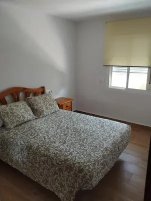 a living room with a table and a couch at Casa juani in Rota