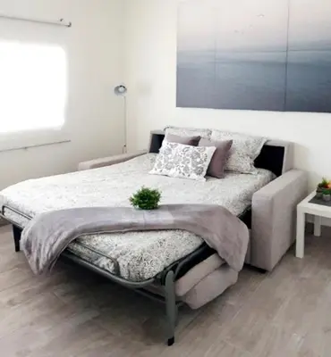 a bedroom with a large bed with pillows on it at Apartamento Plaza Calzada 2 in Sanlúcar de Barrameda