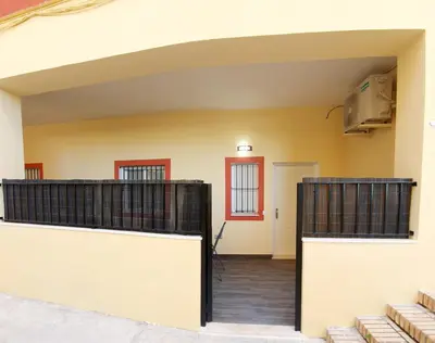a garage with two gates in a house at Apartamento Plaza Calzada 2 in Sanlúcar de Barrameda