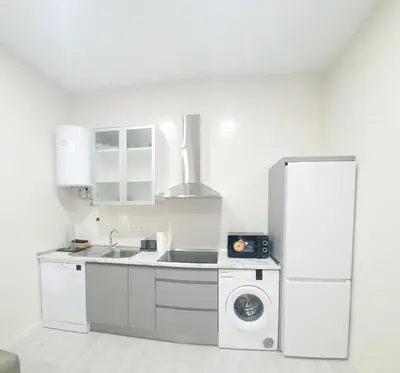 a kitchen with a refrigerator and a washing machine at Apartamento Plaza Calzada 2 in Sanlúcar de Barrameda