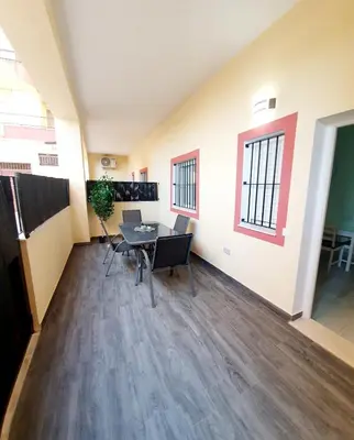 an empty office with a table and chairs in a room at Apartamento Plaza Calzada 2 in Sanlúcar de Barrameda