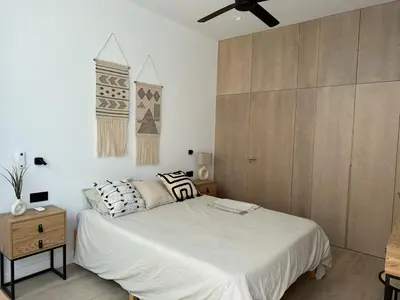 a bedroom with a bed and a ceiling fan at VILLA MARIAH Barrosa Playa in Novo Sancti Petri