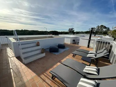 a deck with chairs and a hot tub on a roof at VILLA MARIAH Barrosa Playa in Novo Sancti Petri