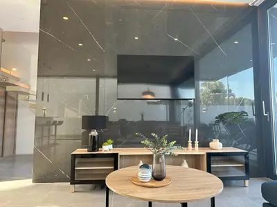 a room with a table and a large glass wall at VILLA MARIAH Barrosa Playa in Novo Sancti Petri