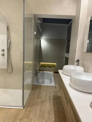 a bathroom with two sinks and a bath tub at VILLA MARIAH Barrosa Playa in Novo Sancti Petri