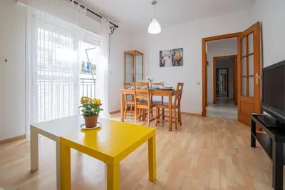 a living room with a table and a yellow coffee table at El Rosal de Huertas in Cádiz
