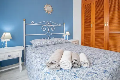 a bedroom with a bed with towels on it at El Rosal de Huertas in Cádiz
