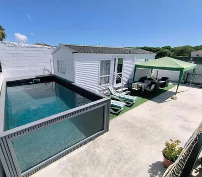 a swimming pool in front of a house at Casa en Chiclana de la Frontera, Playa La Barrosa in Chiclana de la Frontera