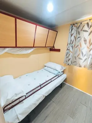 a small room with a bed and a window at Casa en Chiclana de la Frontera, Playa La Barrosa in Chiclana de la Frontera