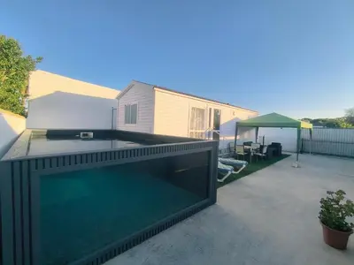 a large swimming pool on the back of a house at Casa en Chiclana de la Frontera, Playa La Barrosa in Chiclana de la Frontera