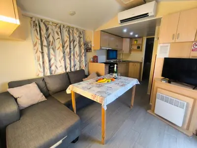 a living room with a couch and a table at Casa en Chiclana de la Frontera, Playa La Barrosa in Chiclana de la Frontera