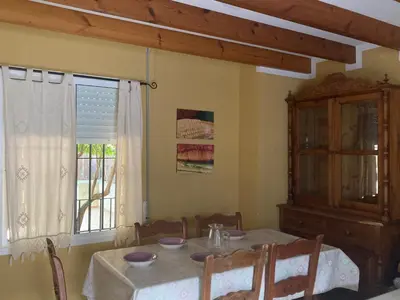a dining room with a table and a window at Al sur del sur in Sanlúcar de Barrameda
