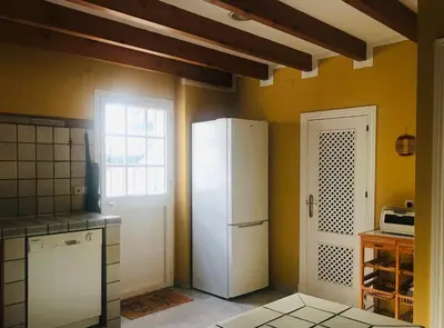 a kitchen with a white refrigerator and a window at Al sur del sur in Sanlúcar de Barrameda