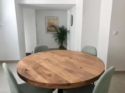 a dining room with a wooden table and chairs at Apartamento en Plaza Plateros in Jerez de la Frontera