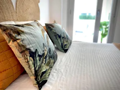 a bed with two pillows on top of it at MyChoice Frida in Rota