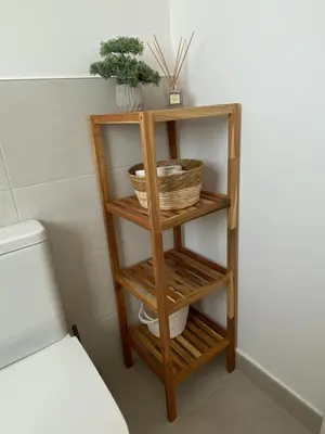 a wooden shelf with a basket and a plant at MyChoice Frida in Rota