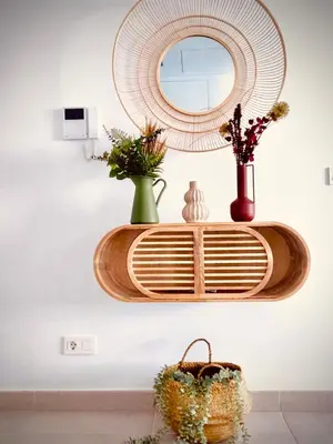 a shelf with vases and a mirror on a wall at MyChoice Frida in Rota