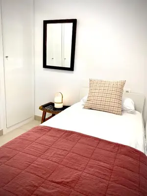 a bedroom with a large bed with a red blanket at MyChoice Frida in Rota