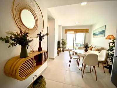 a living room with a table and a mirror at MyChoice Frida in Rota