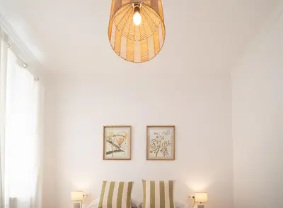 a room with two chairs and a pendant light at SibsSanlucar Duquesa Loft Coqueto Ideal Parejas in Sanlúcar de Barrameda
