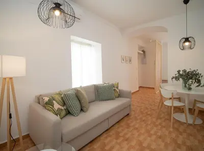 a living room with a couch and a table at SibsSanlucar Duquesa Loft Coqueto Ideal Parejas in Sanlúcar de Barrameda