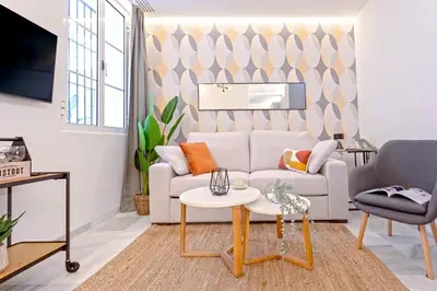 a living room with a couch and a table at Genteel Home Catedral Cádiz in Cádiz