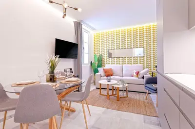 a living room with a couch and a table at Genteel Home Catedral Cádiz in Cádiz