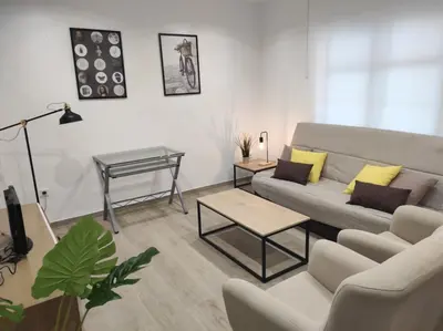 a living room with a couch and a table at Arco Centro Cádiz in Cádiz